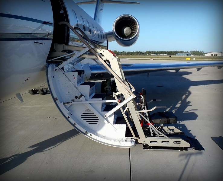 Wheelchair lift positioned alongside a private jet for boarding in Philadelphia, Pennsylvania